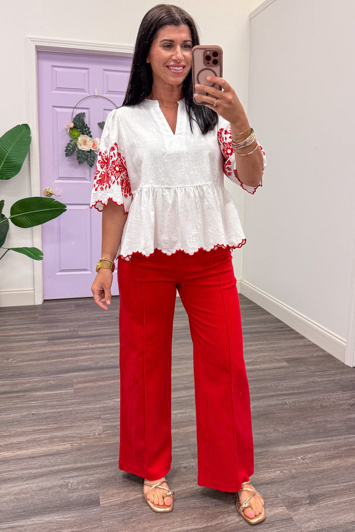 ivory scallop trim v neckline peplum top with red embroidered flower details