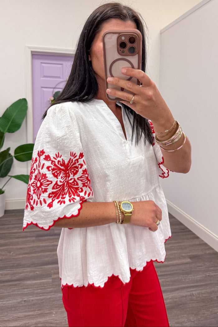 ivory scallop trim short sleeve peplum top with red embroidered flower details