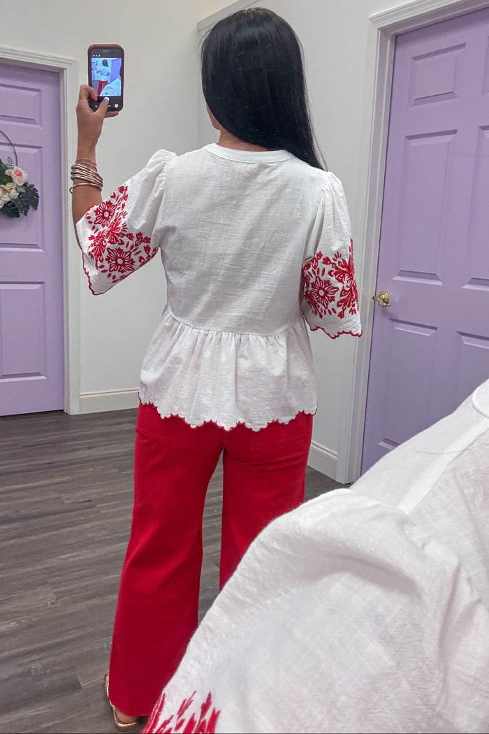 ivory scallop trim peplum top with red embroidered floral details back view