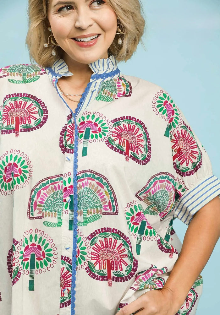 Umgee button front cream top with multicolor abstract print and a ruffled neck in plus size