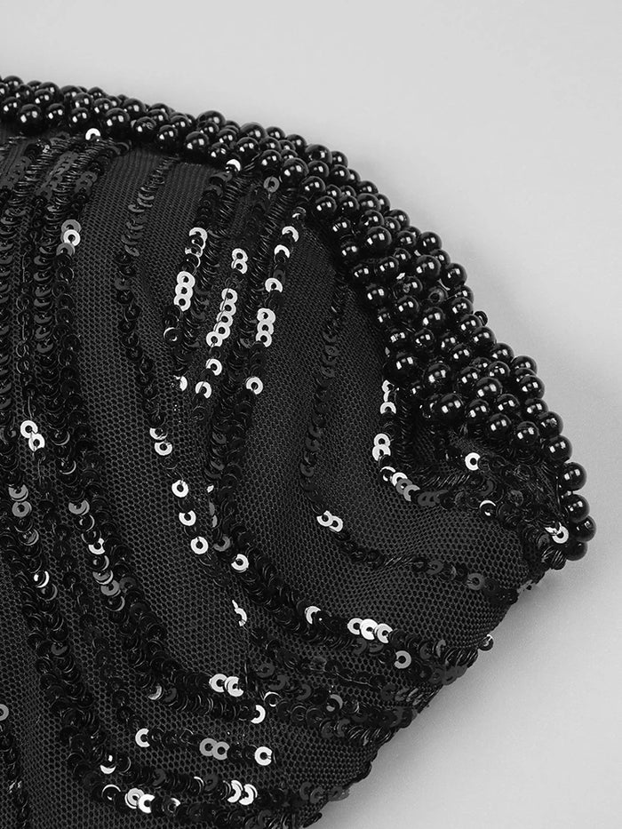 Black strapless mini dress with pearl chains, sequins, feathers, and geometric embellishments for homecoming, cocktail, and evening parties.