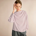 Woman wearing a light purple blouse against a beige background | Lead