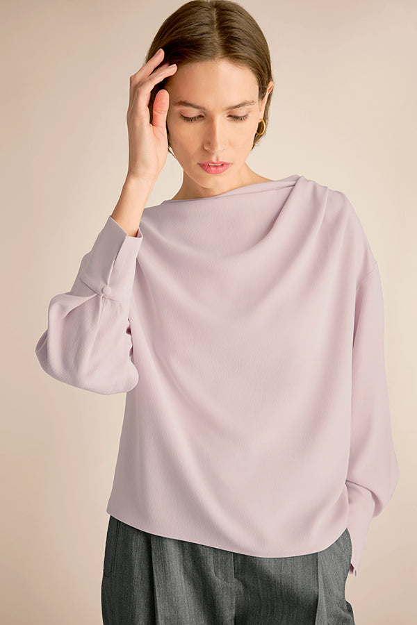 Woman wearing a light purple blouse with a neutral background | Exclude | Grid