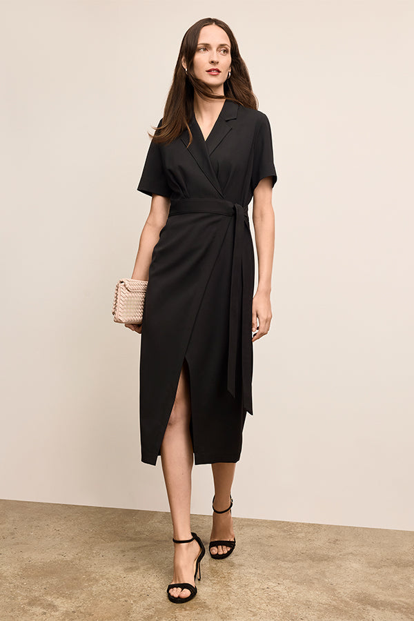 Woman wearing a black dress with a beige wall background | Exclude | Grid