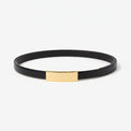 Black belt with a gold tag on a white background | Lead