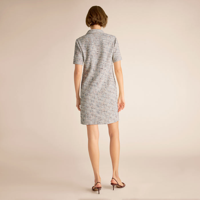 Woman wearing a gray dress on a beige background