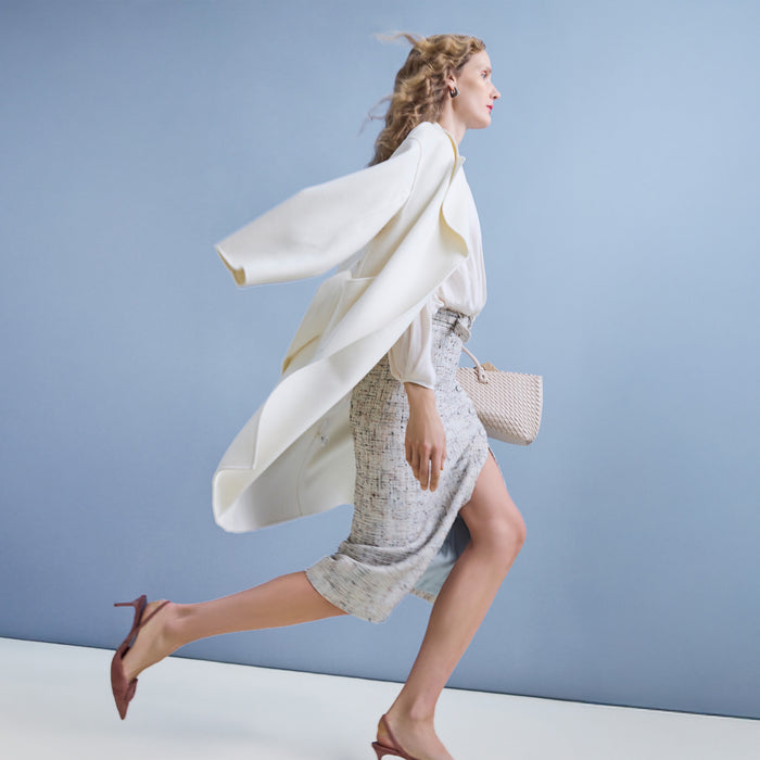 Woman in a white outfit with a light blue background