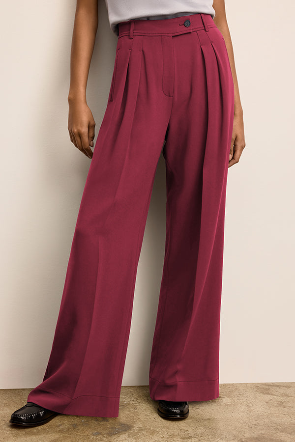 Maroon pleated pants worn by a person against a plain background | Grid | Exclude