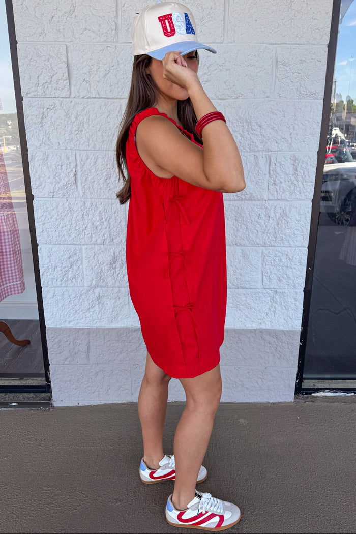 solid red linen mini dress with decorative bow tie detail down sides