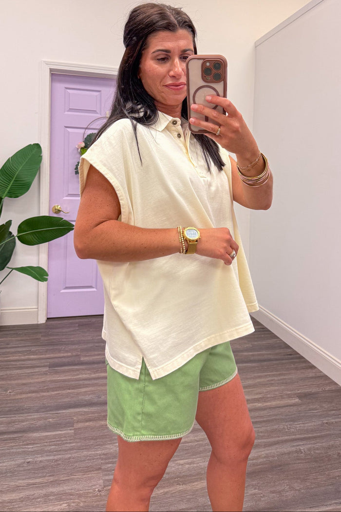 solid cream mineral washed cap sleeve polo top with bottom hem side slits