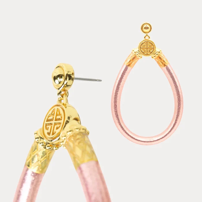 Close up of Budhagirl Gold and rose gold hoop earrings with post back