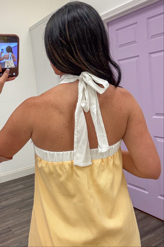 yellow with cream trim sleeveless halter style tie back midi dress