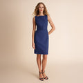 Woman wearing a blue dress on a beige background | Lead
