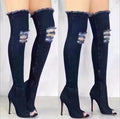 Denim thigh high boots with tassels and high heels.