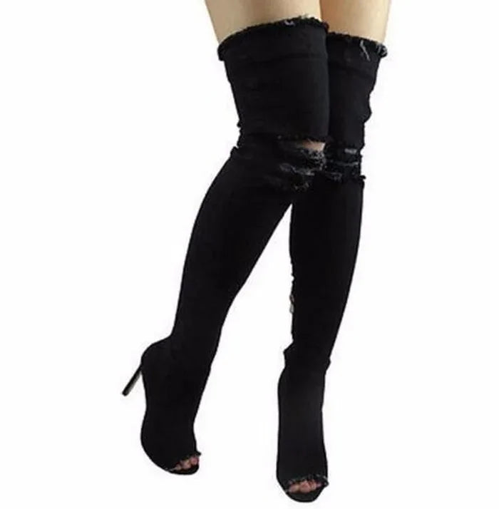 Denim thigh high boots with tassels and high heels.