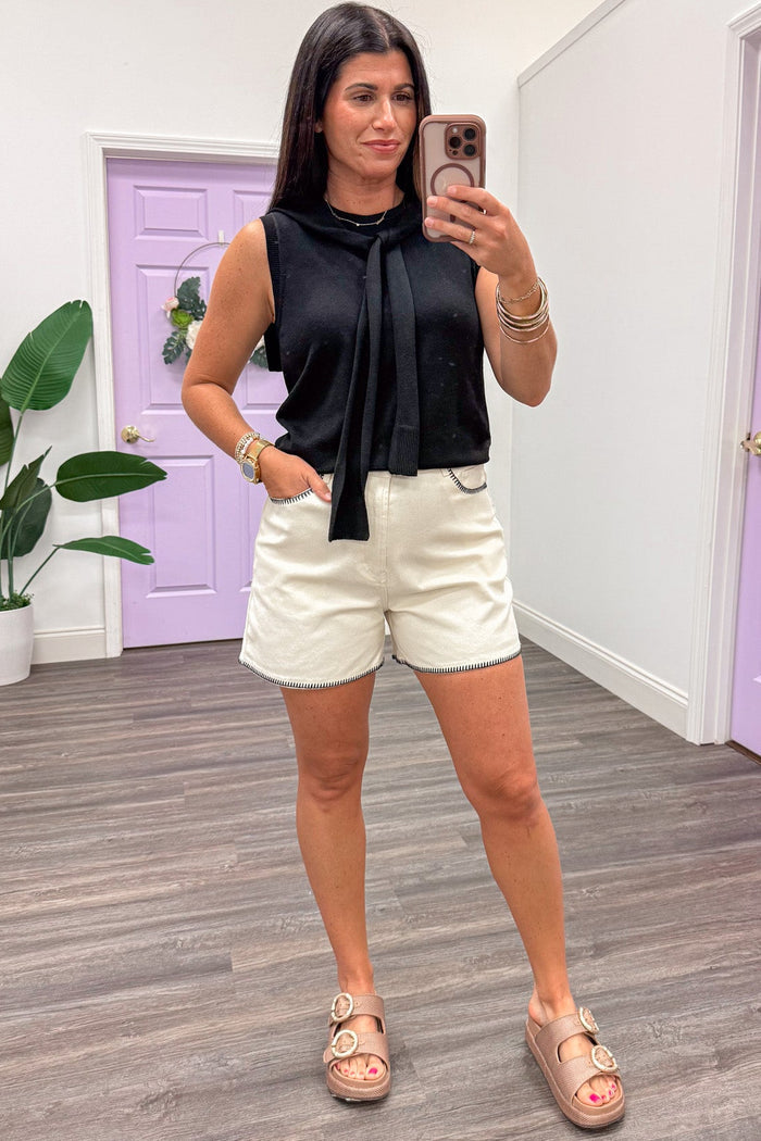 solid black sleeveless lightweight knit top with attached self tie drape scarf