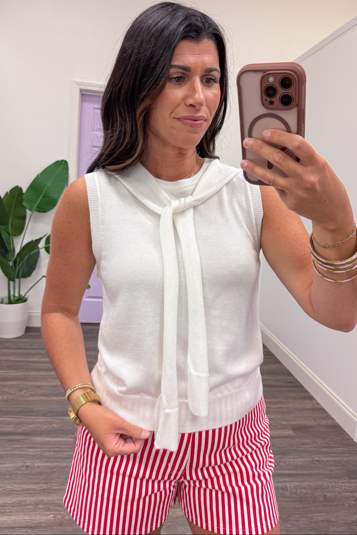solid ivory ribbed hem sleeveless knit top with self tie drape scarf detail