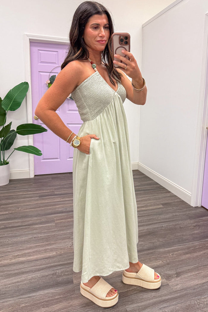 solid dusty sage green sleeveless v neckline halter midi dress with side pockets