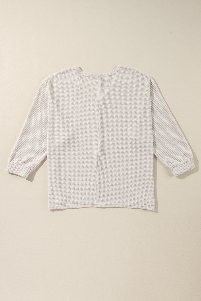 Haut ample à col en V et fentes latérales en tricot *