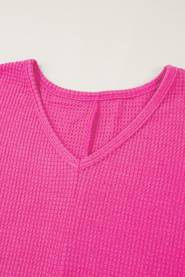 Haut ample à col en V et fentes latérales en tricot *