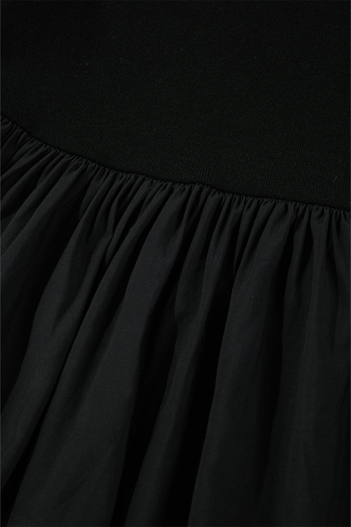 Haut patchwork péplum noir en tricot côtelé à manches longues et encolure dégagée