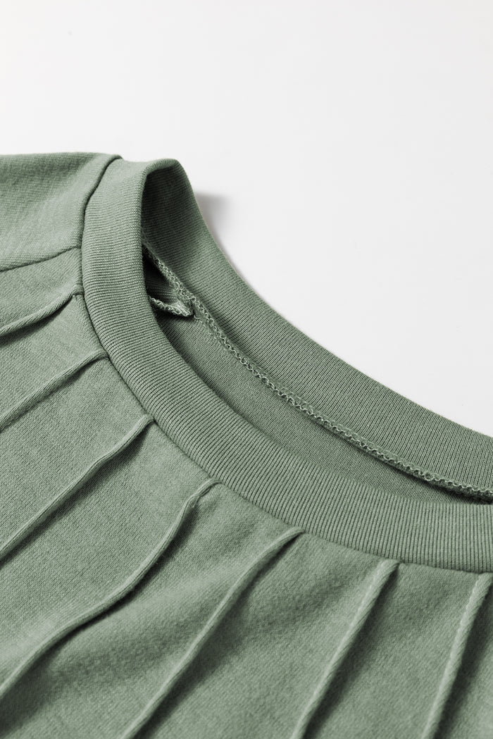 Haut vert herbe à manches raglan et poignets contrastés en dentelle avec coutures contrastées