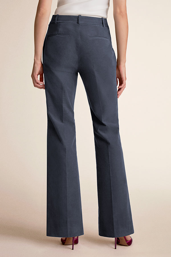 Dark gray pants worn by a person on a beige background | Grid Hover | Exclude