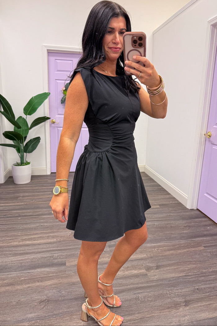 solid black sleeveless mini dress with crew neckline and side pockets