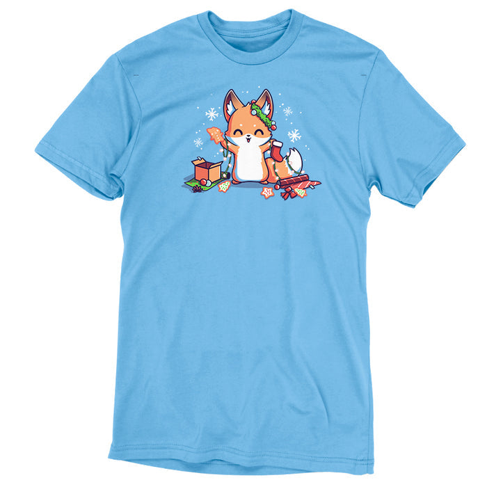Premium Cotton T-shirt_TeeTurtle It's That Time of Year light blue t-shirt featuring a cheerful fox with green garland around its left ear surrounded by snowflakes and holding a red holiday stocking in one hand a Christmas cookie and a string of lights in the other. On the floor is red gift wrap, a red bow, Christmas cookies and a brown box on top of green gift wrap.