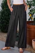 Jean noir smocké taille haute à jambes larges et poches latérales