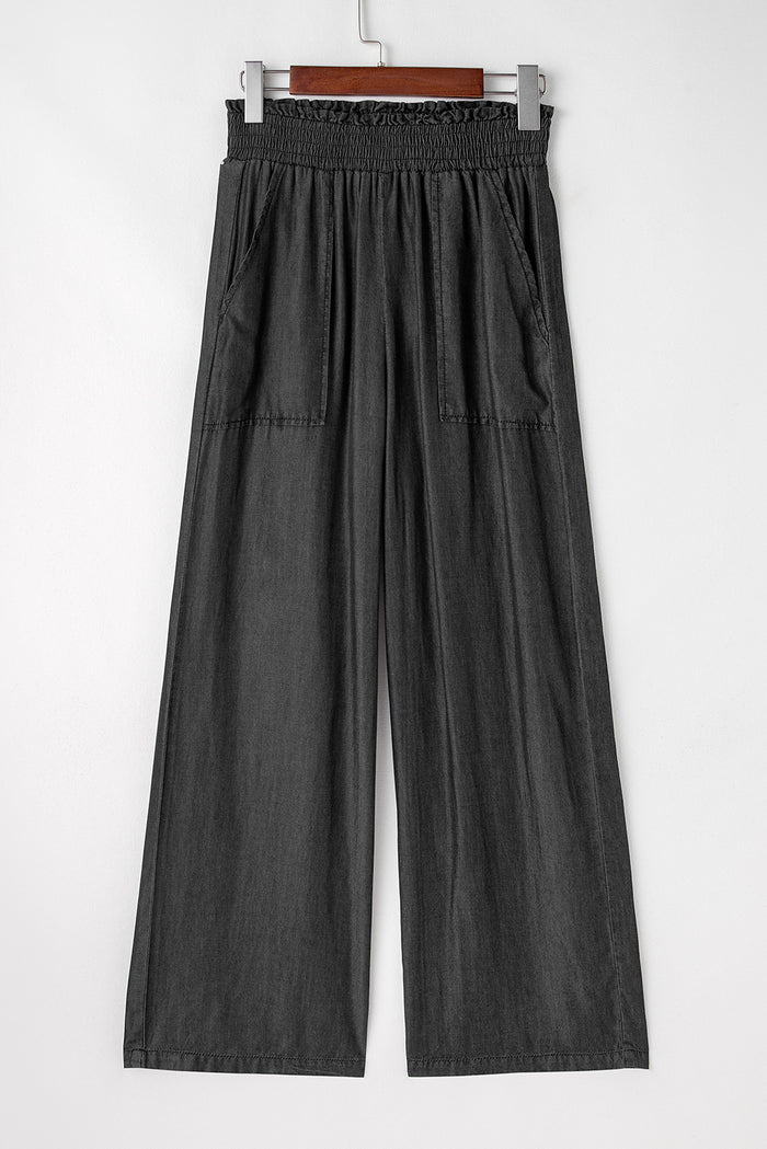 Jean noir smocké taille haute à jambes larges et poches latérales