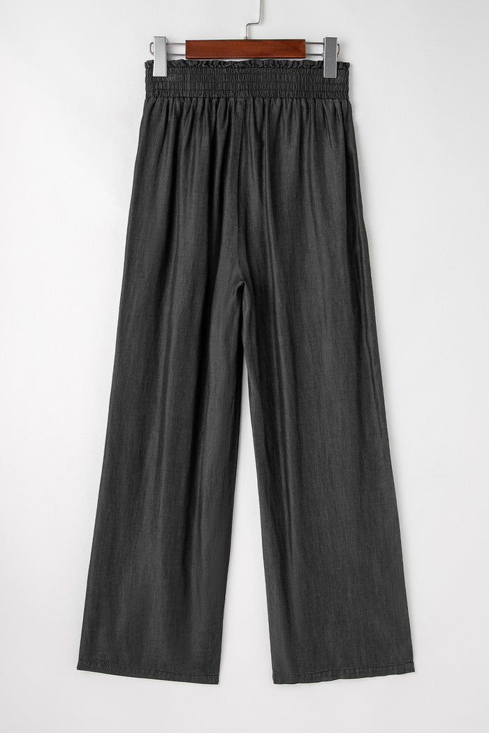 Jean noir smocké taille haute à jambes larges et poches latérales