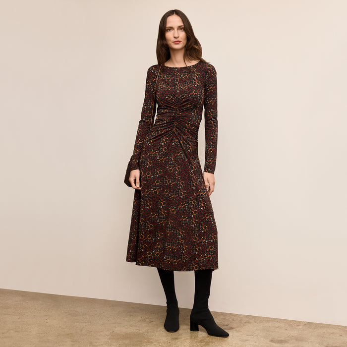 Woman wearing a patterned dress against a plain background | Lead