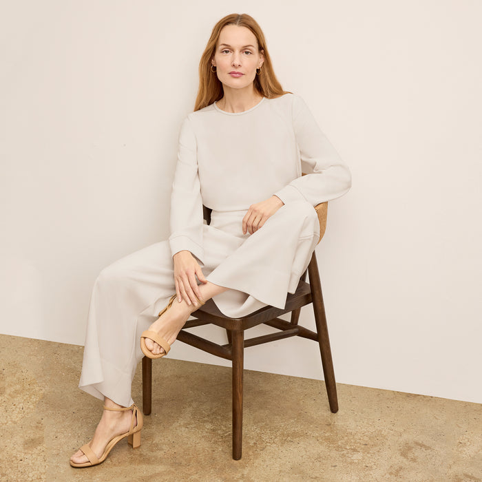 front image of a woman wearing the jules top in eggshell