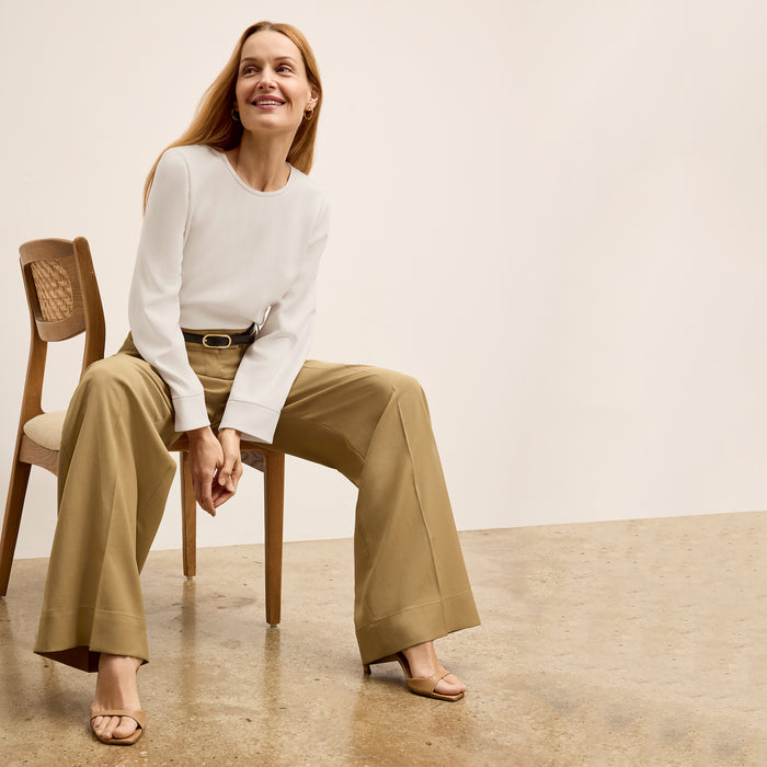 front image of a woman wearing the jules top in eggshell
