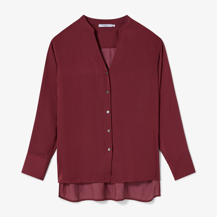 Maroon blouse with a layered design on a white background