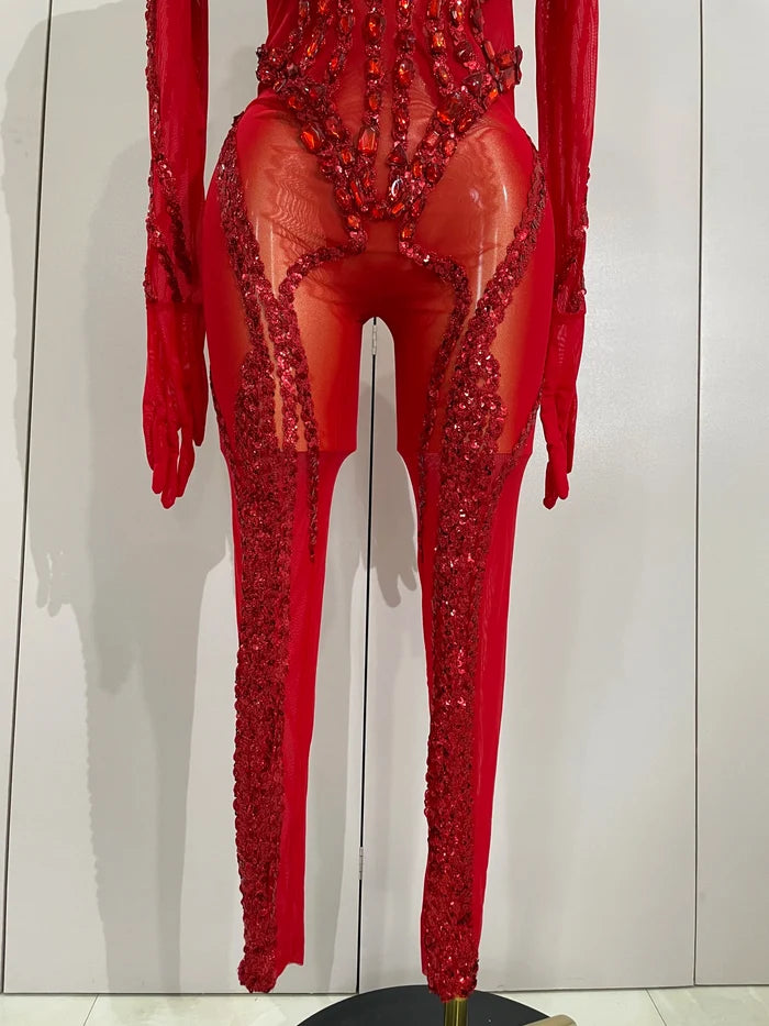 Luxury sheer rhinestone mesh jumpsuit with glittering diamonds and sequins for festival or stage wear.