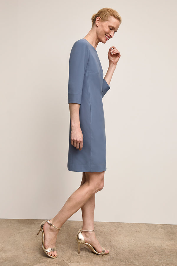 Front image of a woman wearing Lancia  Dress Dusty Blue | Exclude
