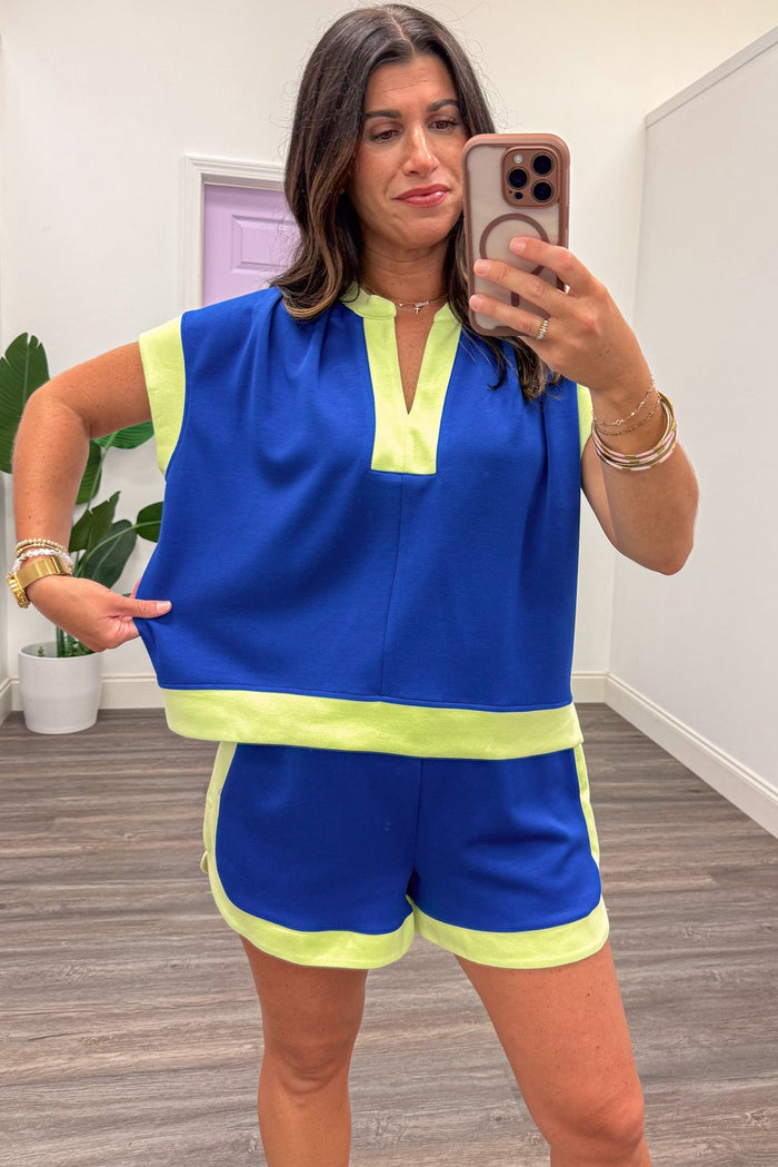 royal blue with lime colorblock trim capped sleeve v neckline relaxed silhouette knit top