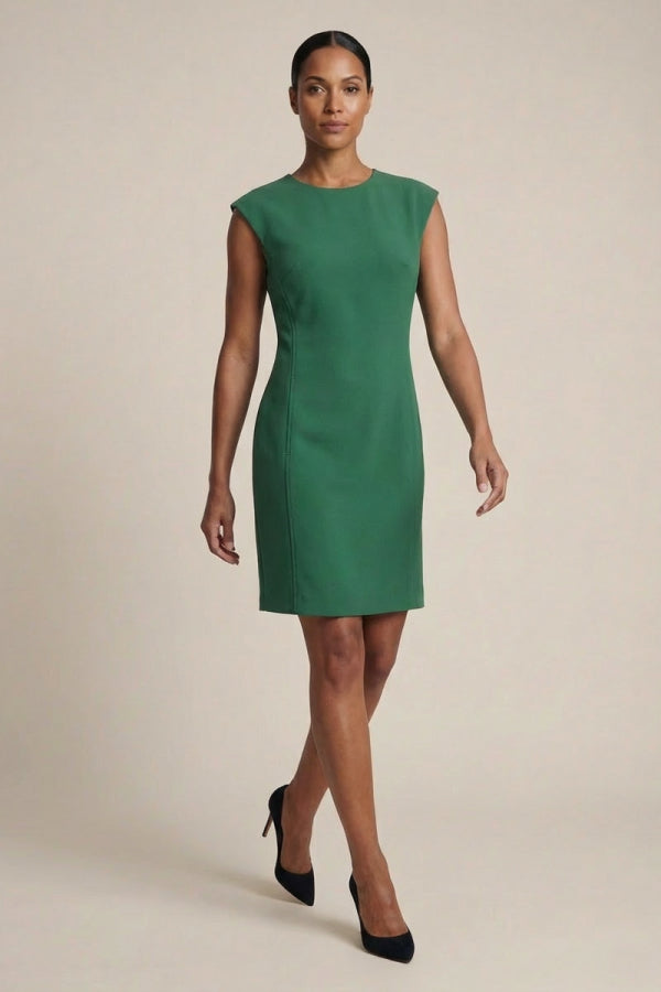 Woman wearing a green dress against a beige background | Grid | Exclude
