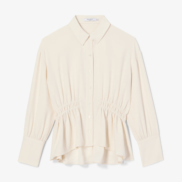 Beige blouse on a white background