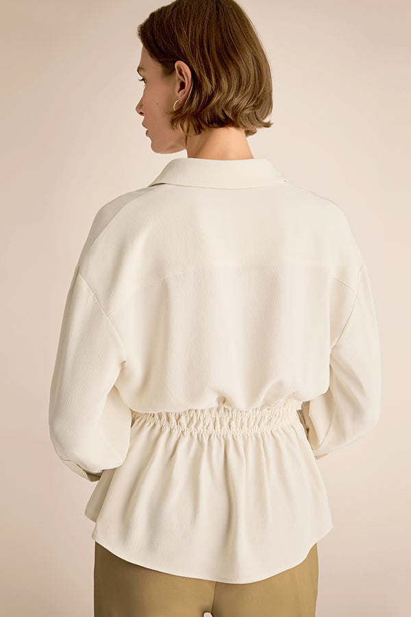 Woman wearing a white blouse with a plain background | Exclude