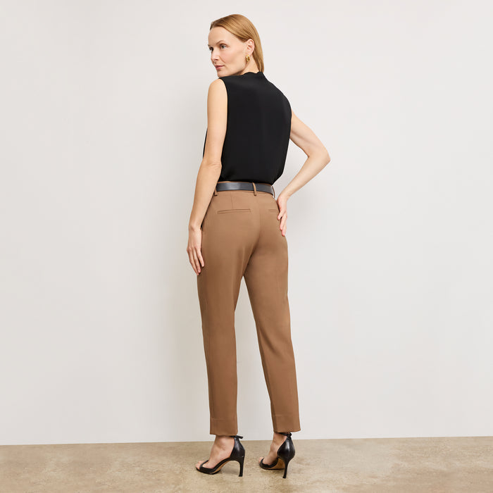 image of a woman standing wearing the Mejia pant in camel