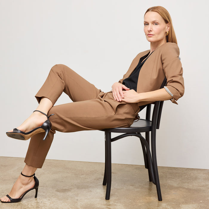 image of a woman standing wearing the Mejia pant in camel