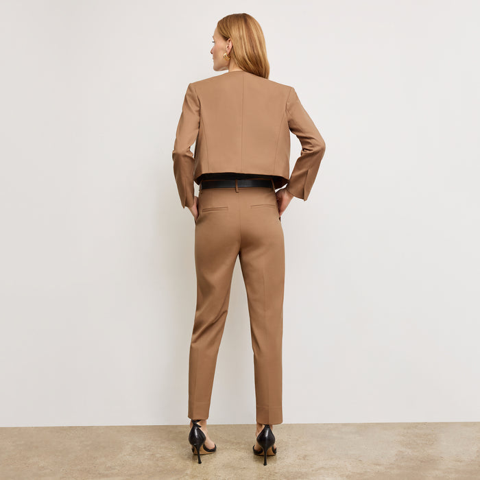 image of a woman standing wearing the Mejia pant in camel