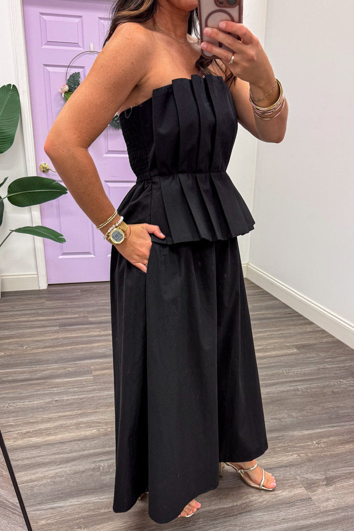 solid black pleated bodice peplum waist strapless midi dress with side pockets