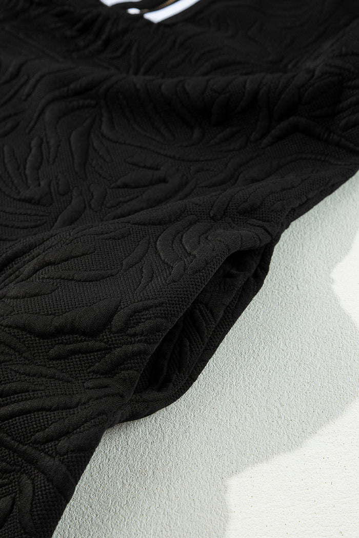 Mini-robe droite noire texturée en jacquard avec fermeture éclair sur un quart
