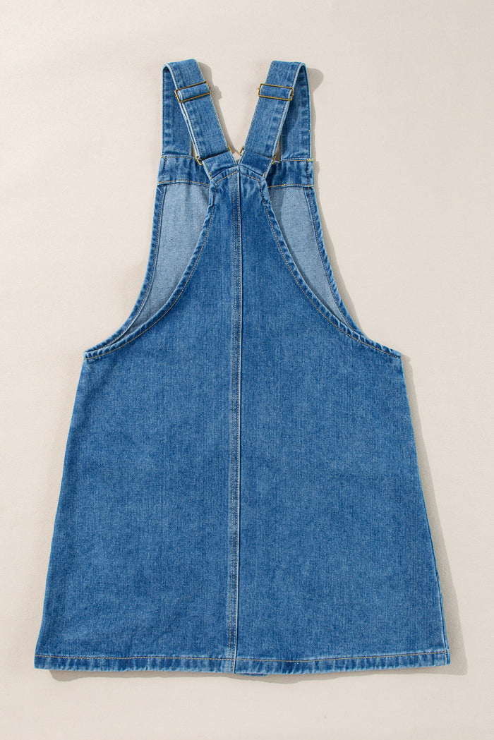 Mini-robe en jean bleu crépuscule à larges bretelles boutonnées avec poches sur le devant