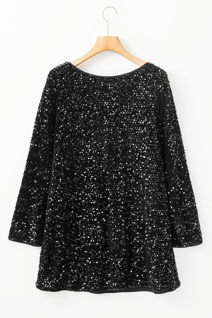 Mini-robe noire à paillettes et manches longues avec nœud découpé dans le dos