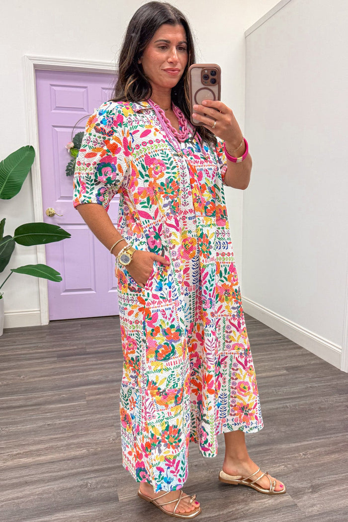 bright multi-colored folk art style floral print short sleeve v neckline midi dress with side pockets